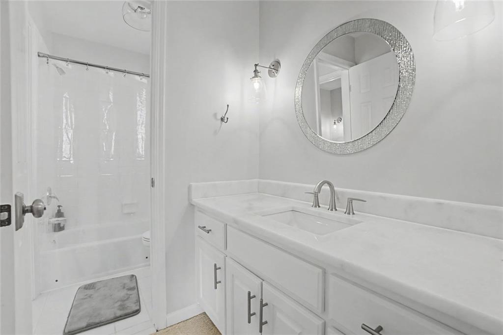 2018 Cockrell Pointe Northwest Kennesaw, GA 30152 - Photo 24 of 51 a bathroom with a sink a vanity and a mirror