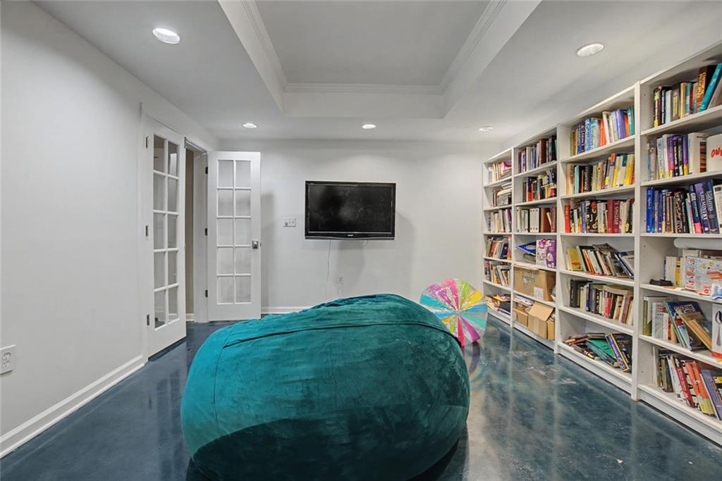 2018 Cockrell Pointe Northwest Kennesaw, GA 30152 - Photo 30 of 51 a living room with television and a book shelf