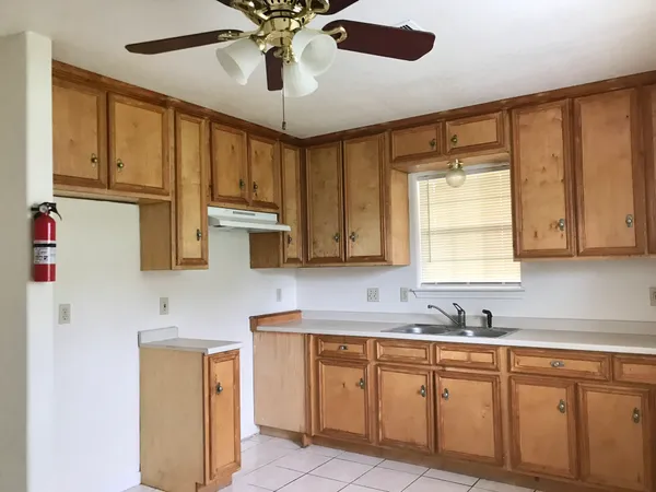 a kitchen with cabinets stainless steel appliances and a window