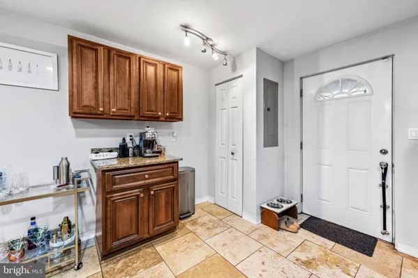 a kitchen with granite countertop a stove a sink and a refrigerator