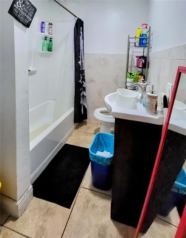 a bathroom with a sink a toilet and a shower