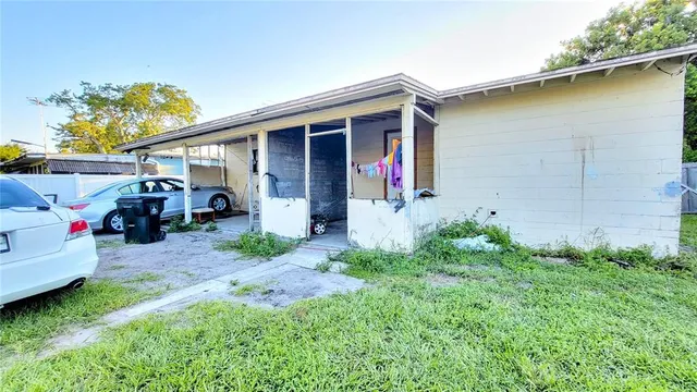 a front view of a house with a garden and parking