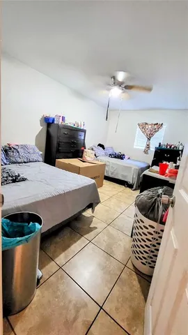 a bedroom with furniture and a potted plant