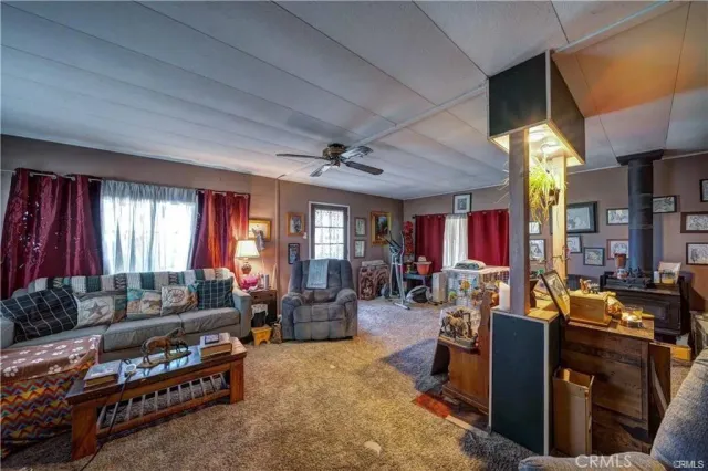 a living room with furniture fireplace and window