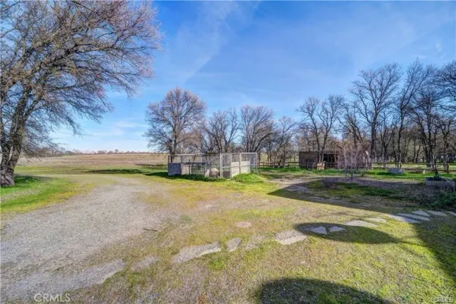 a view of a fountain in front of a house with a yard