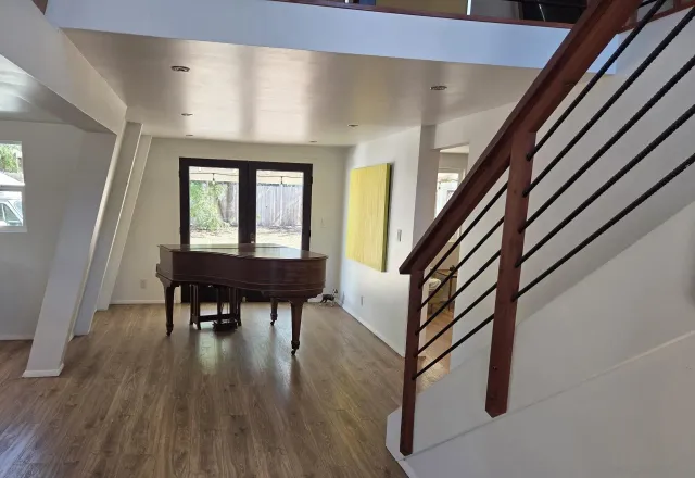 a view of a livingroom with furniture and hardwood floor