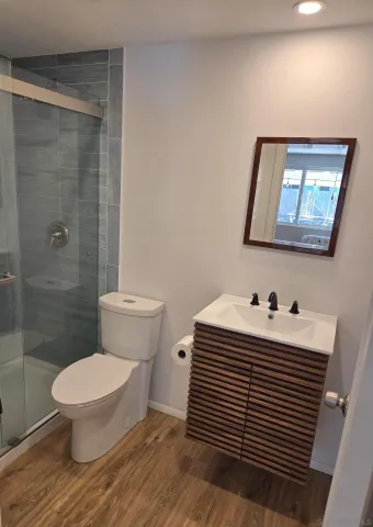 a bathroom with a toilet sink a shower and a mirror