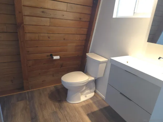 a white toilet sitting next to a shower