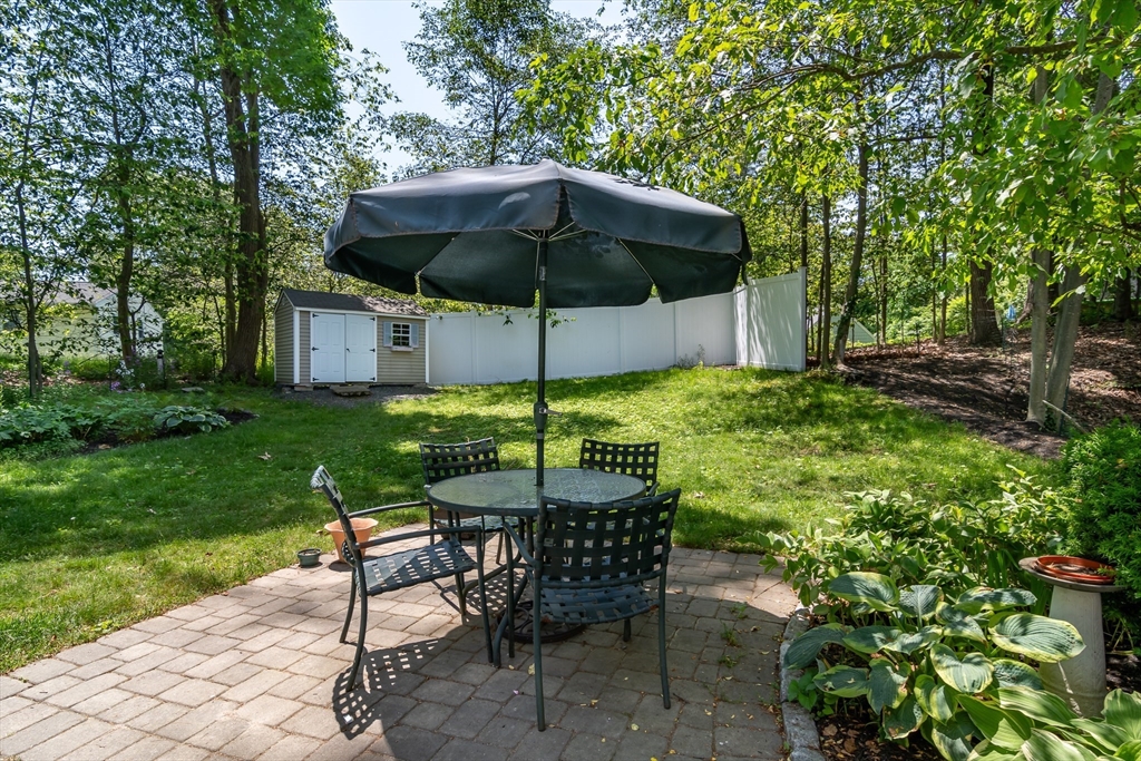 62 Sycamore Road Wayland, MA 01778 - Photo 14 of 16 a view of a table and chairs under an umbrella
