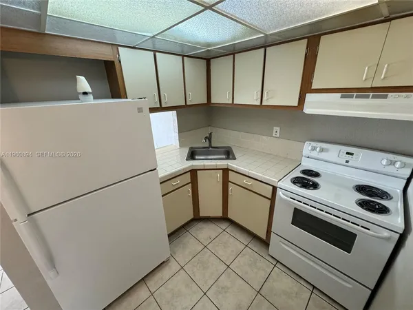 a white refrigerator freezer sitting inside of a kitchen