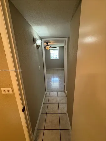 en empty room with window and hardwood floor