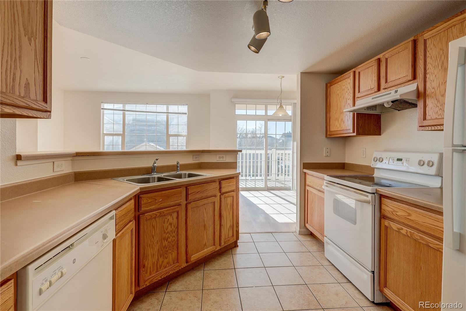5756 North Genoa Way, Unit 12208 Aurora, CO 80019 - Photo 11 of 33 a kitchen with stainless steel appliances a sink stove and cabinets