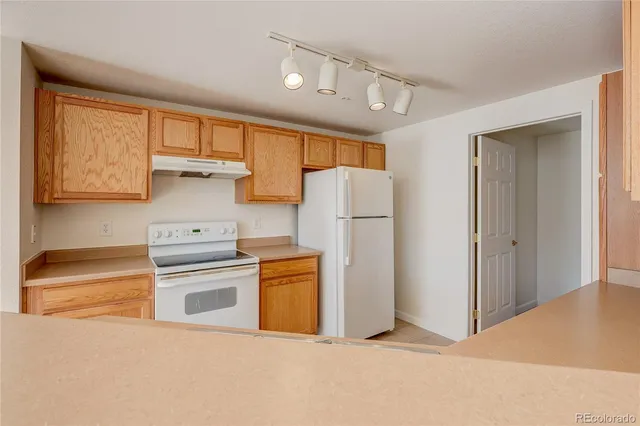 a kitchen with refrigerator a stove a washer and dryer