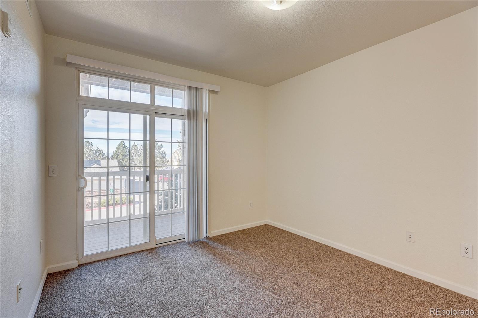 5756 North Genoa Way, Unit 12208 Aurora, CO 80019 - Photo 23 of 33 an empty room with windows
