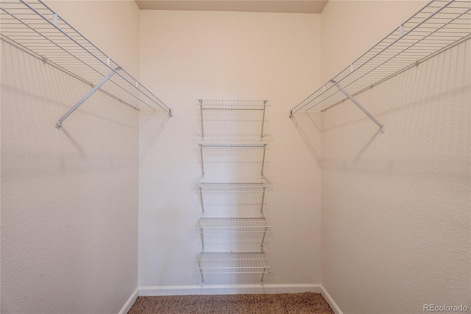 5756 North Genoa Way, Unit 12208 Aurora, CO 80019 - Photo 27 of 33 a view of walk in closet with empty racks