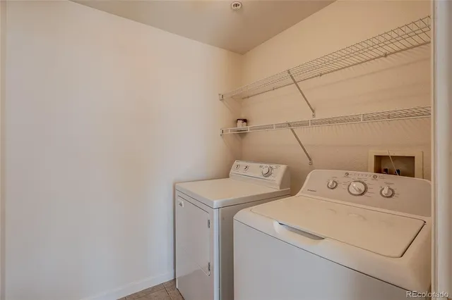 a view of a house with a big yard and a large tree