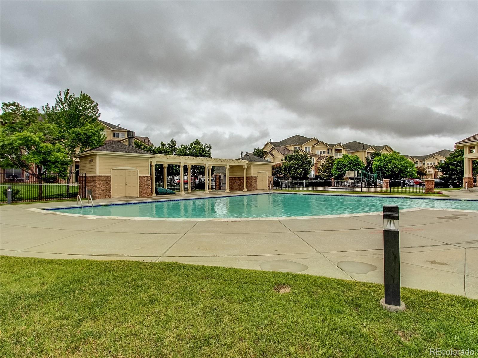 5756 North Genoa Way, Unit 12208 Aurora, CO 80019 - Photo 31 of 33 a view of a house with a big yard and a large tree