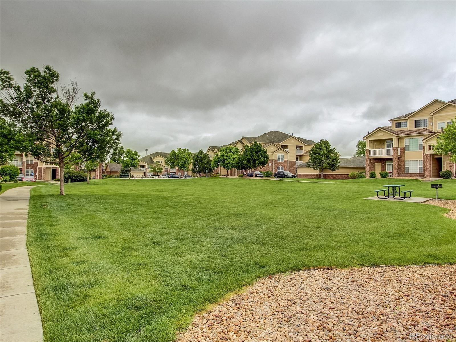 5756 North Genoa Way, Unit 12208 Aurora, CO 80019 - Photo 32 of 33 a city view with tall trees and a big yard