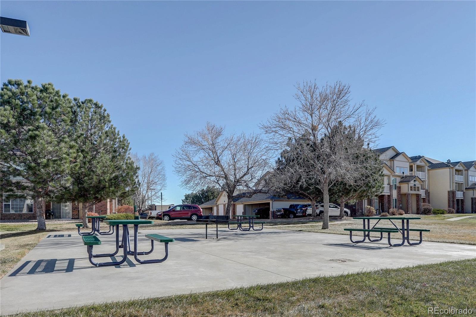 5756 North Genoa Way, Unit 12208 Aurora, CO 80019 - Photo 33 of 33 a swimming pool with outdoor seating and trees
