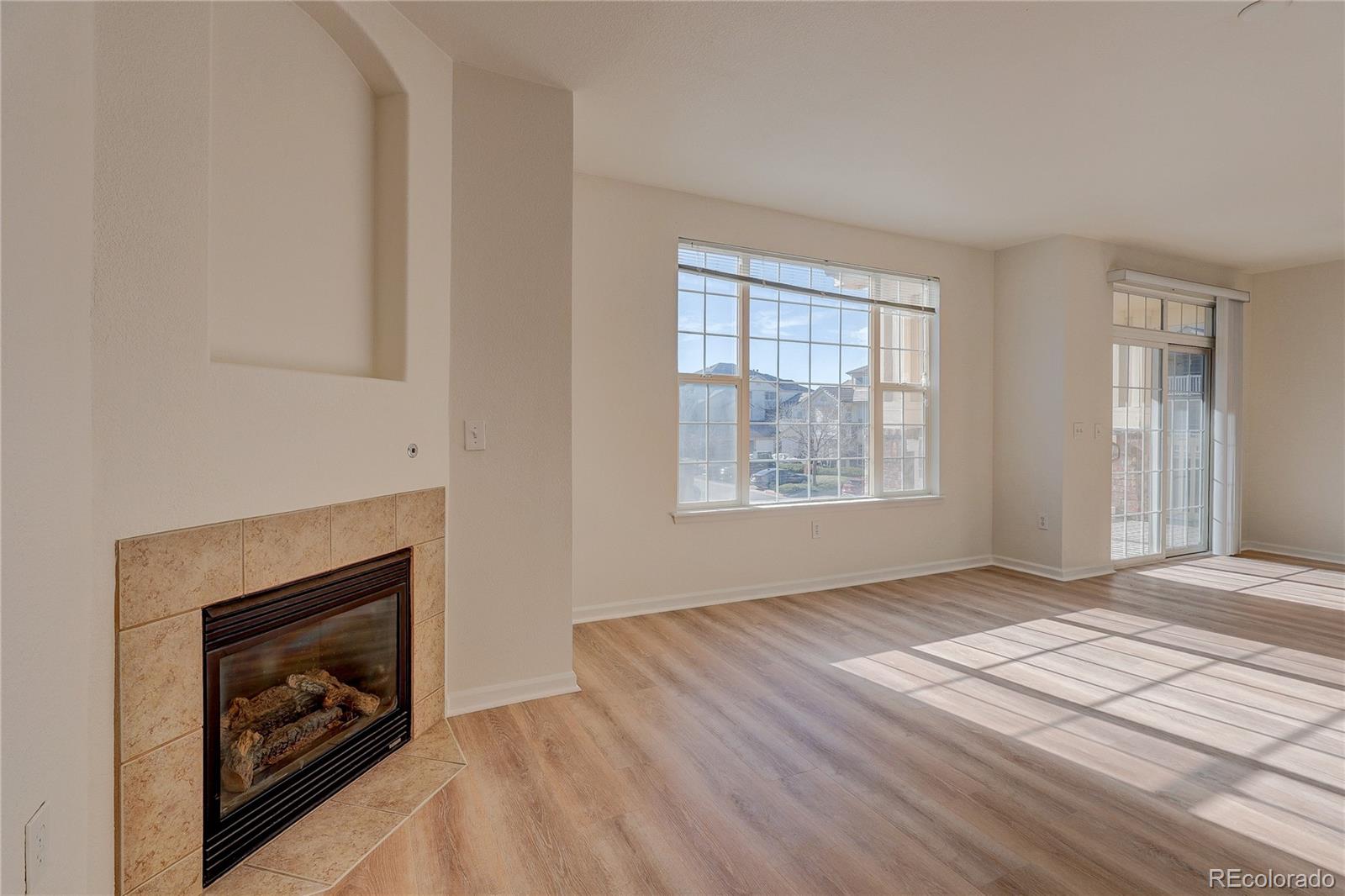 5756 North Genoa Way, Unit 12208 Aurora, CO 80019 - Photo 6 of 33 a view of an empty room with window and fire place