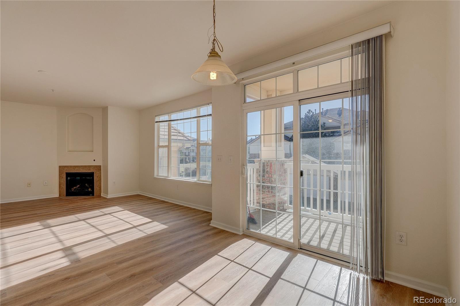 5756 North Genoa Way, Unit 12208 Aurora, CO 80019 - Photo 9 of 33 a view of livingroom with hardwood floor and window