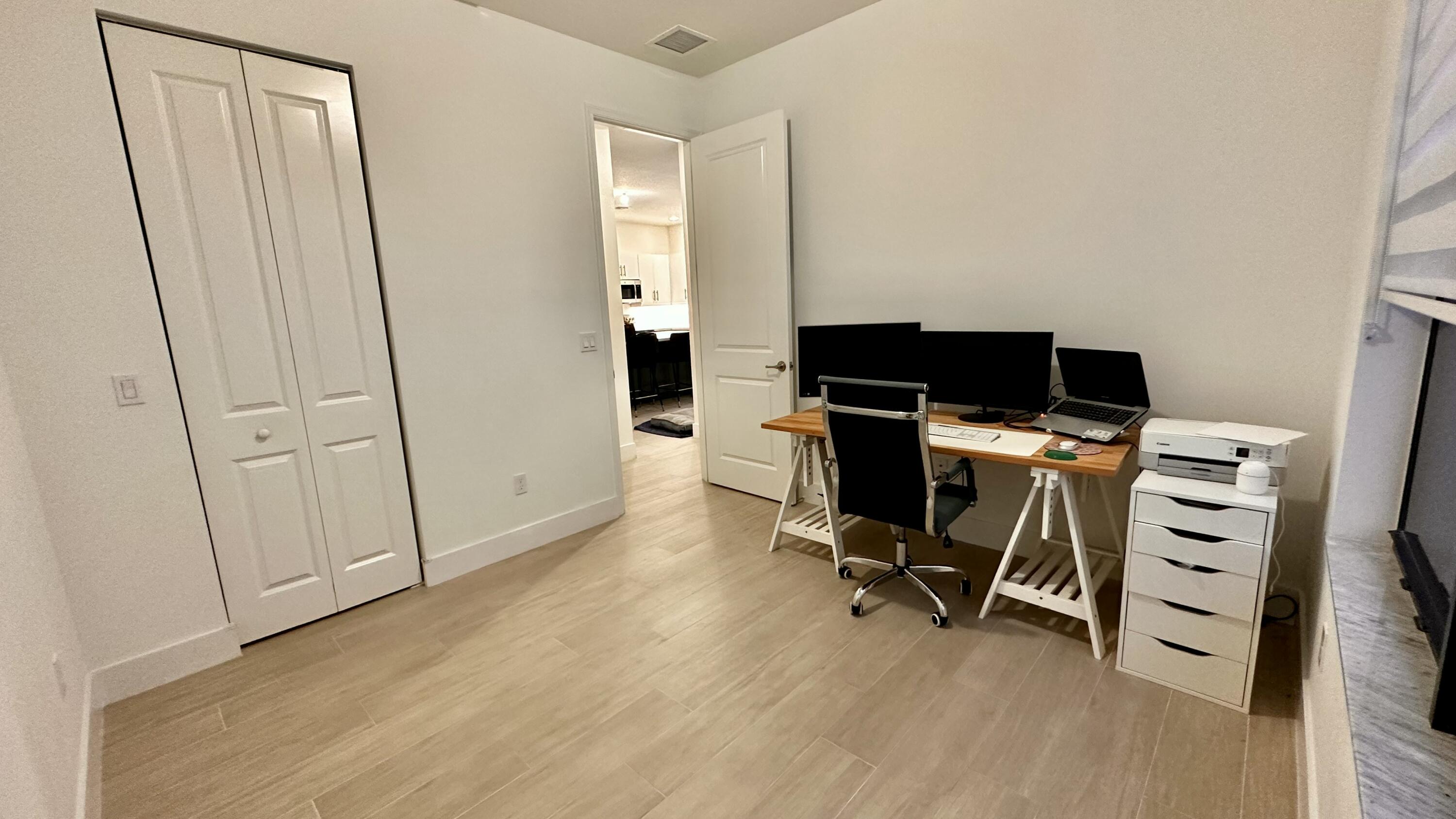 5570 Quiet Lake Place Westlake, FL 33470 - Photo 12 of 18 a view of a workspace with furniture and wooden floor