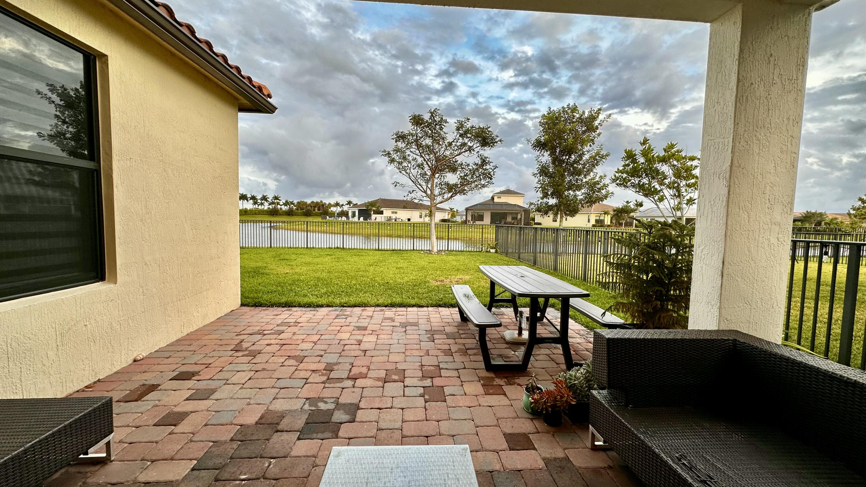 5570 Quiet Lake Place Westlake, FL 33470 - Photo 2 of 18 a view of a chairs and table on the terrace