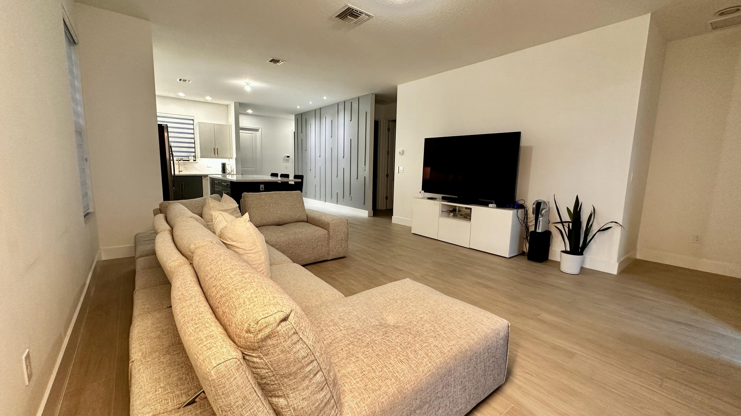 5570 Quiet Lake Place Westlake, FL 33470 - Photo 4 of 18 a living room with furniture and a flat screen tv