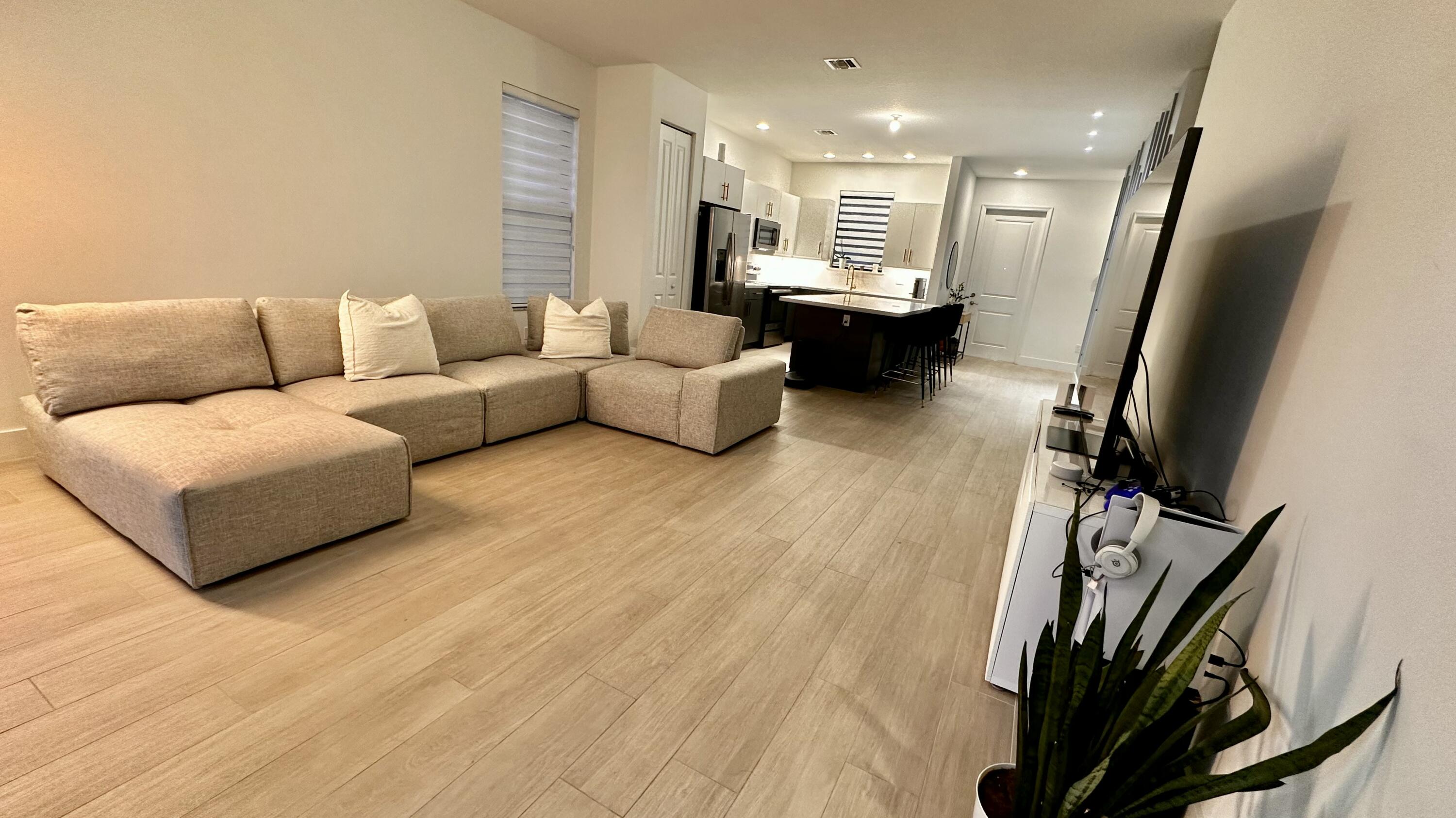 5570 Quiet Lake Place Westlake, FL 33470 - Photo 5 of 18 a living room with furniture fireplace and a flat screen tv