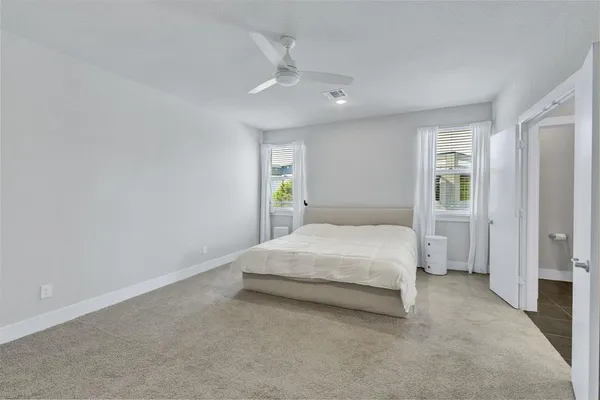 a spacious bedroom with a bed and a window