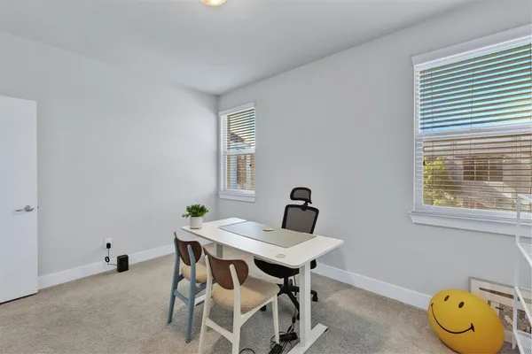a view of a dining room with furniture and window