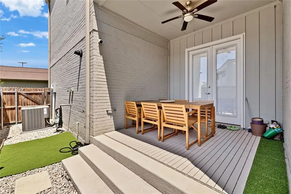 a balcony with table and chairs
