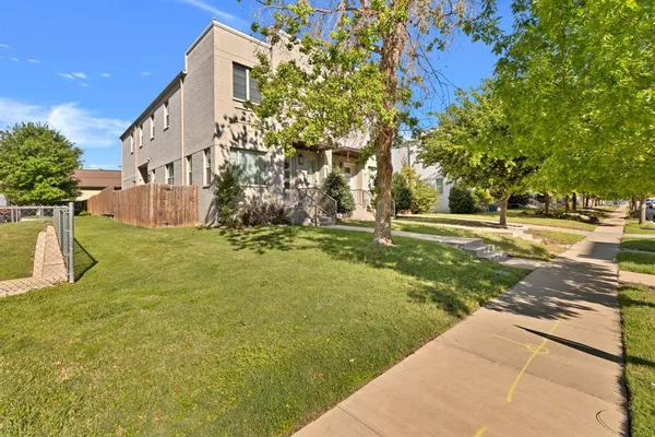 a backyard of a house with lots of green space and fountain
