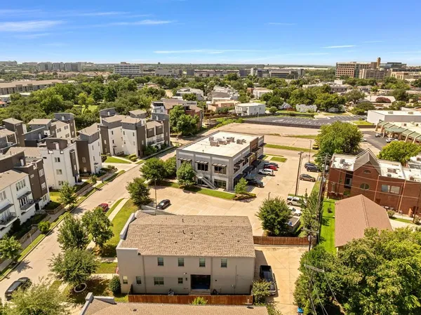 an aerial view of residential houses with outdoor space