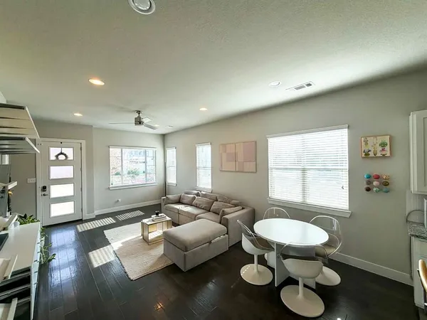 a living room with furniture and a wooden floor
