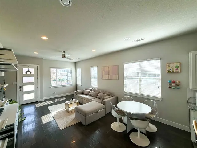 a living room with furniture and a wooden floor