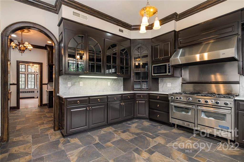 1107 Queens Road Charlotte, NC 28207 - Photo 14 of 44 a kitchen with stainless steel appliances granite countertop a stove and a sink