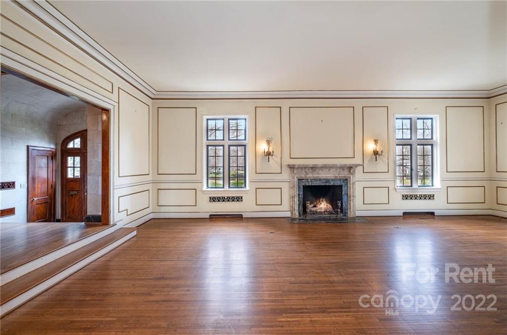 1107 Queens Road Charlotte, NC 28207 - Photo 16 of 44 wooden floor fireplace and windows in an empty room