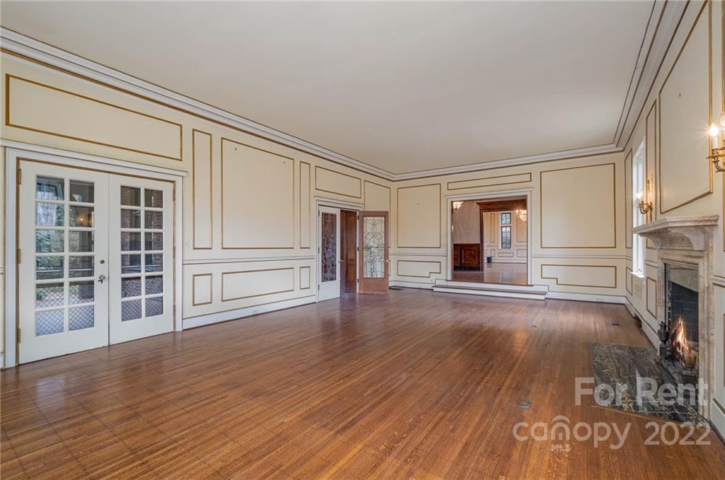 1107 Queens Road Charlotte, NC 28207 - Photo 17 of 44 a view of empty room with wooden floor and fireplace