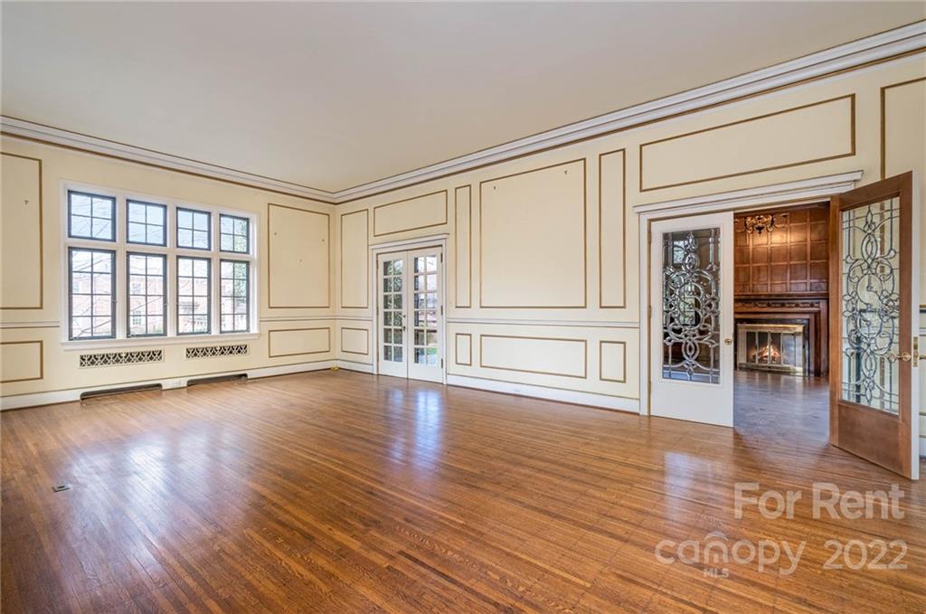 1107 Queens Road Charlotte, NC 28207 - Photo 18 of 44 a view of empty room with wooden floor and fireplace