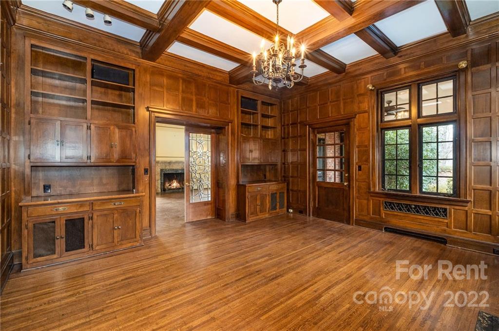 1107 Queens Road Charlotte, NC 28207 - Photo 20 of 44 a view of an empty room with a window and wooden floor