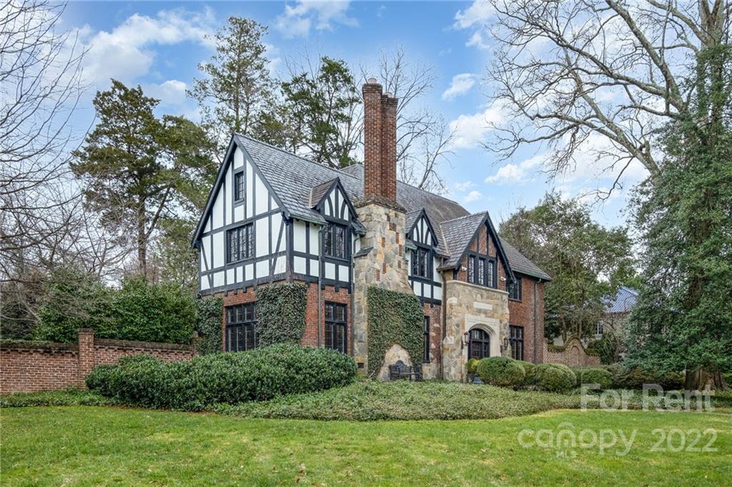 1107 Queens Road Charlotte, NC 28207 - Photo 2 of 44 a view of a brick house with a yard and plants