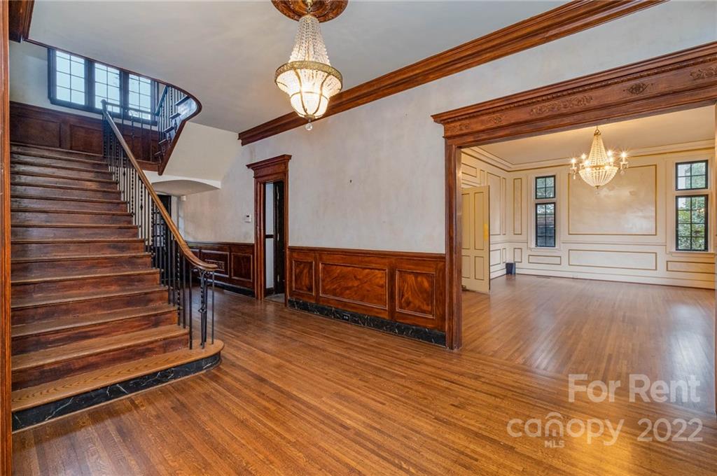 1107 Queens Road Charlotte, NC 28207 - Photo 21 of 44 a view of a livingroom with wooden floor and stairs