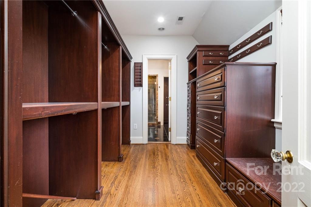 1107 Queens Road Charlotte, NC 28207 - Photo 26 of 44 a view of walk in closet with wooden floor