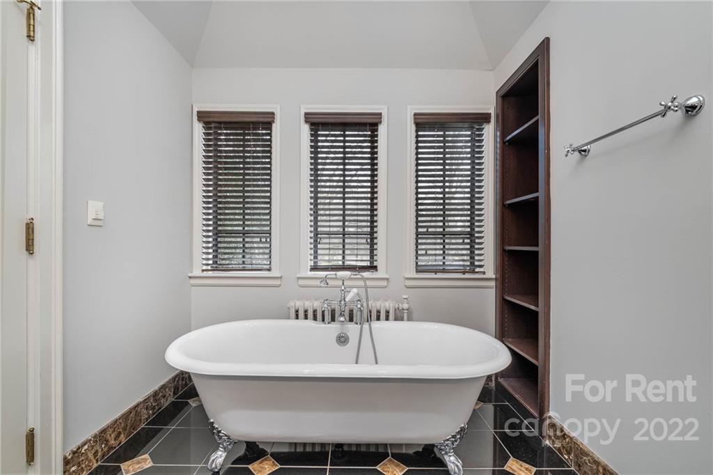 1107 Queens Road Charlotte, NC 28207 - Photo 28 of 44 a white sink sitting in a bathroom next to a window