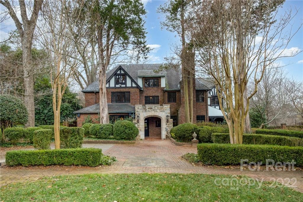 1107 Queens Road Charlotte, NC 28207 - Photo 3 of 44 a front view of a house with garden and trees