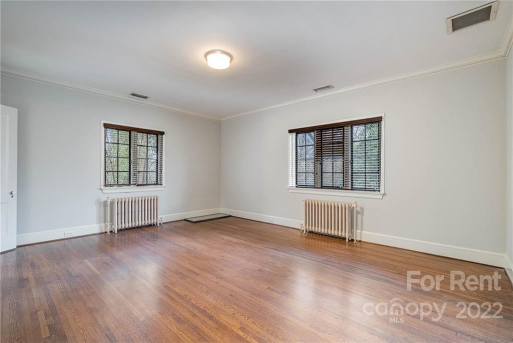1107 Queens Road Charlotte, NC 28207 - Photo 31 of 44 an empty room with wooden floor and windows