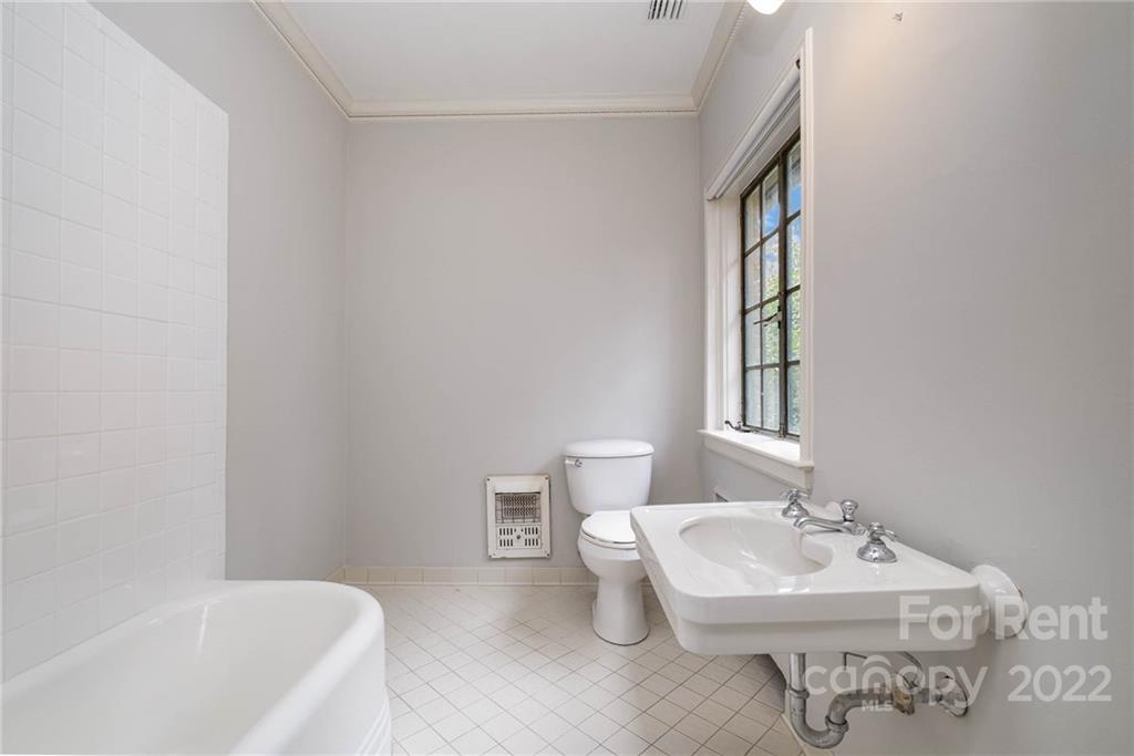 1107 Queens Road Charlotte, NC 28207 - Photo 32 of 44 a bathroom with a sink a toilet and bathtub