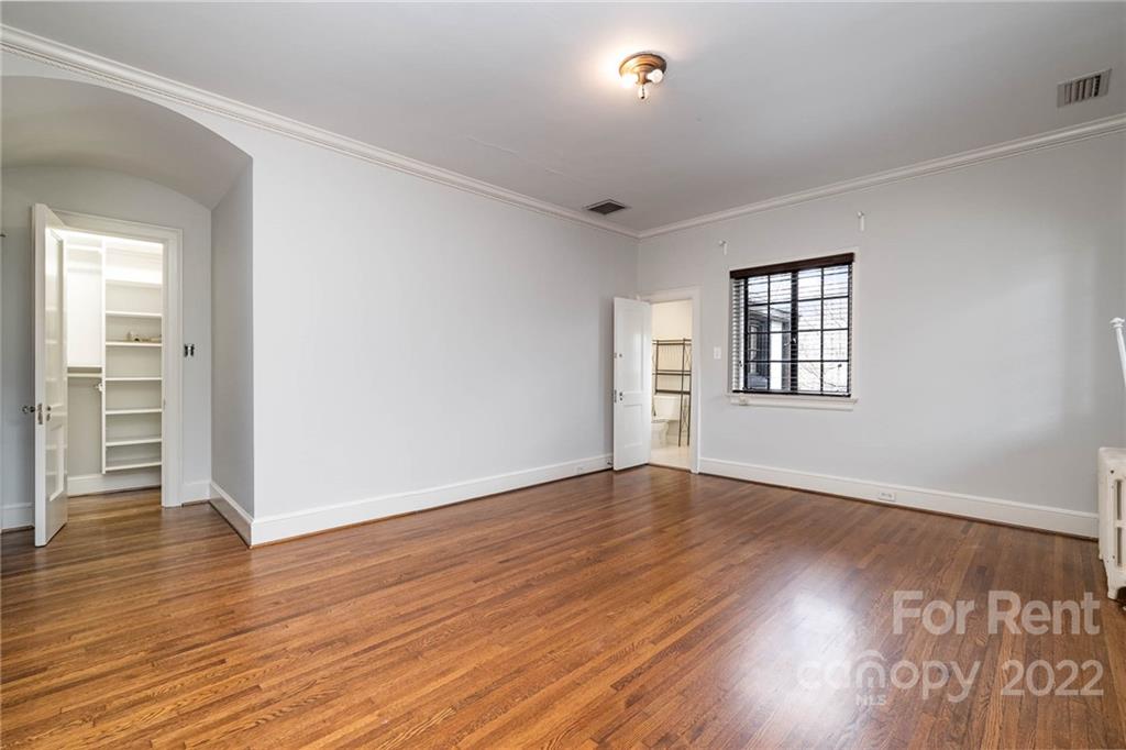 1107 Queens Road Charlotte, NC 28207 - Photo 34 of 44 an empty room with wooden floor and windows