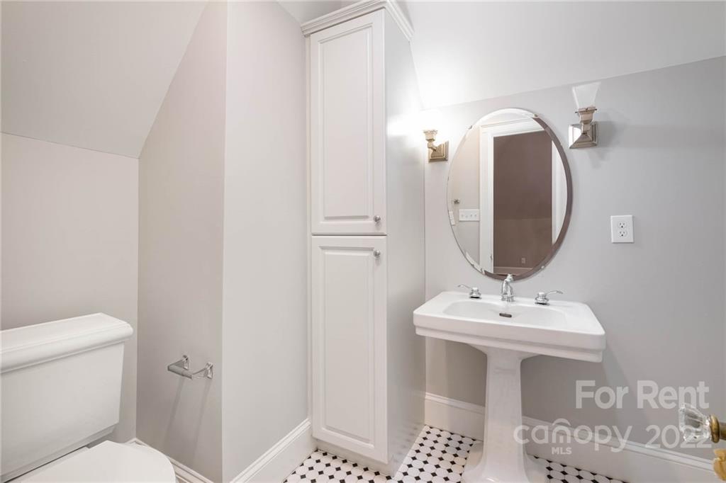 1107 Queens Road Charlotte, NC 28207 - Photo 38 of 44 a bathroom with a sink toilet and a mirror